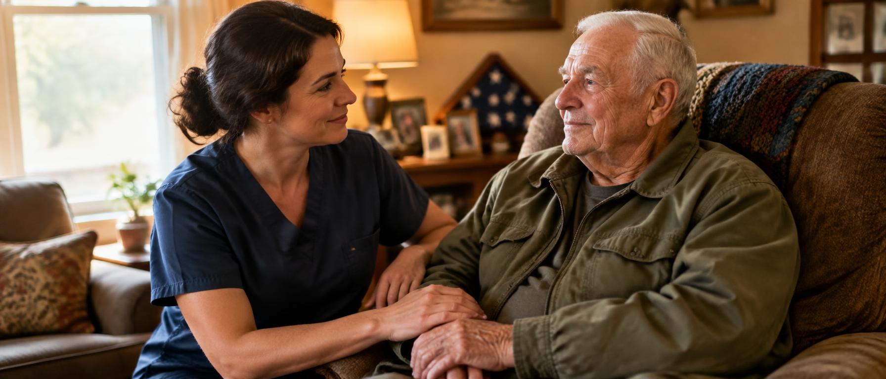 A caregiver sitting beside an elderly veteran at home, sharing a quiet moment